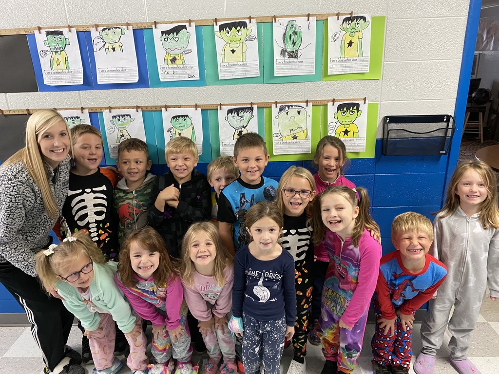 Mrs. Hubbard dressed in pajamas with all of 1st grade