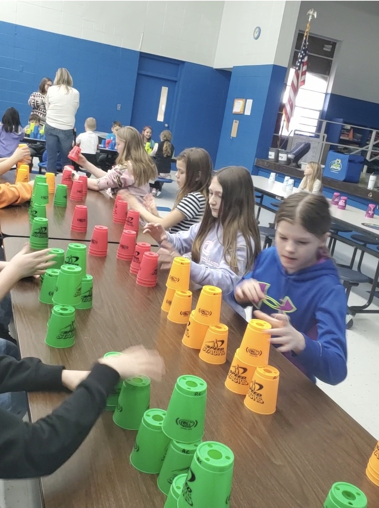 Students playing a cup stacking game